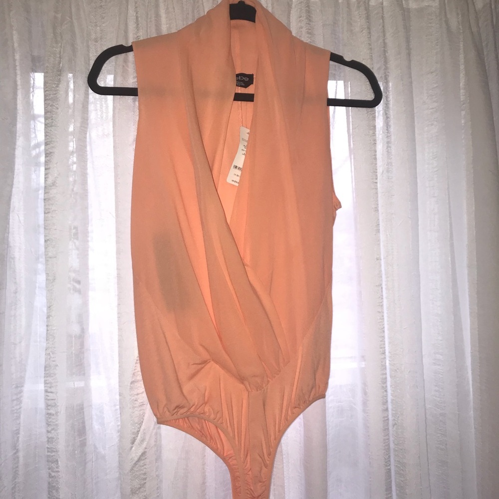BEBE Deep plunge silk body suit.